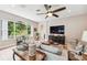 Comfortable living room featuring a large sectional sofa and flat screen TV at 11519 Belle Haven Dr, New Port Richey, FL 34654