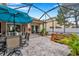 Screened patio with dining area, hot tub, and lush landscaping at 11519 Belle Haven Dr, New Port Richey, FL 34654