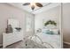 Charming bedroom with a white iron bed and dresser at 11519 Belle Haven Dr, New Port Richey, FL 34654