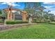 Watersedge community entrance features a beautiful wooden arch and landscaping at 11519 Belle Haven Dr, New Port Richey, FL 34654