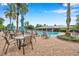 Inviting pool area with tables, chairs, and lounge chairs at 11519 Belle Haven Dr, New Port Richey, FL 34654