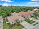 The house has a tile roof, large front yard, two-car garage, and is situated on a quiet street at 11519 Belle Haven Dr, New Port Richey, FL 34654