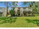 Back exterior view of townhouse with private patio and grassy yard at 103 Brigadoon Dr, Clearwater, FL 33759