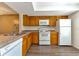 Modern kitchen with wood cabinets, white appliances and ample counter space at 103 Brigadoon Dr, Clearwater, FL 33759