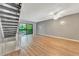 Living area with grey walls, wood-look floors, and a staircase at 103 Brigadoon Dr, Clearwater, FL 33759