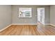 Light-filled living room with wood-look floors and view to kitchen at 103 Brigadoon Dr, Clearwater, FL 33759
