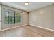 Simple bedroom with wood-look floors and a window at 103 Brigadoon Dr, Clearwater, FL 33759