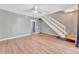 Living room with wood-look floors, ceiling fan and staircase at 103 Brigadoon Dr, Clearwater, FL 33759