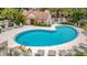 Community kidney-shaped pool with lounge chairs at 103 Brigadoon Dr, Clearwater, FL 33759