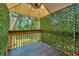 Relaxing covered patio with artificial hedge and ceiling fan at 103 Brigadoon Dr, Clearwater, FL 33759