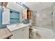 Updated bathroom with white vanity, tub, and stylish tile at 103 Brigadoon Dr, Clearwater, FL 33759
