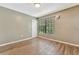 Simple bedroom with wood-look floors and a window at 103 Brigadoon Dr, Clearwater, FL 33759