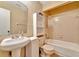 Clean bathroom with bathtub, sink, and storage cabinet at 103 Brigadoon Dr, Clearwater, FL 33759