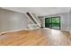 Spacious living room with grey walls, wood-look floors and sliding glass doors at 103 Brigadoon Dr, Clearwater, FL 33759