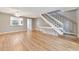 Living room features wood-look floors and staircase to upper level at 103 Brigadoon Dr, Clearwater, FL 33759