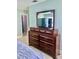 Bedroom with dresser, TV, and access to closet at 6196 Coralberry Ter, Port Charlotte, FL 33981