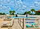 Community swimming pool with surrounding patio and seating at 6196 Coralberry Ter, Port Charlotte, FL 33981