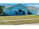 Charming light blue home with well-maintained lawn and landscaping at 6196 Coralberry Ter, Port Charlotte, FL 33981