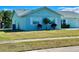 Charming light blue single-story home with a well-manicured lawn at 6196 Coralberry Ter, Port Charlotte, FL 33981