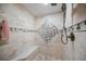 Tiled walk-in shower with a built-in bench and designer accent tile at 1540 Gulf Blvd # 2102, Clearwater Beach, FL 33767