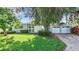 Charming single-story home with a well-manicured lawn and a two-car garage at 161 Overbrook W St, Largo, FL 33770