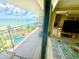 Spacious balcony with views of the beach, pool, and interior living space at 2618 Gulf Blvd # 505, Indian Rocks Beach, FL 33785