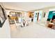 Open concept dining area with a stylish glass table and convenient access to kitchen and living spaces at 2618 Gulf Blvd # 505, Indian Rocks Beach, FL 33785