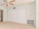 Spacious bedroom with neutral carpeting, built-in shelving and large closet at 2391 Sumatran Way # 55, Clearwater, FL 33763