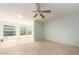 Open concept living space with light walls, wood-look flooring and large windows at 2391 Sumatran Way # 55, Clearwater, FL 33763