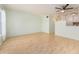 Spacious living room with light walls and wood-look floors, open to kitchen at 2391 Sumatran Way # 55, Clearwater, FL 33763