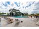 Community pool with plenty of lounge chairs and umbrellas at 2391 Sumatran Way # 55, Clearwater, FL 33763
