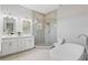 Modern bathroom featuring a soaking tub, double vanity, and glass shower at 2430 6Th N Ave, St Petersburg, FL 33713