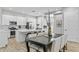 Open kitchen with white cabinetry, an island, and dining area at 2430 6Th N Ave, St Petersburg, FL 33713