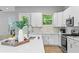 Modern white kitchen with quartz countertops and stainless steel appliances at 2430 6Th N Ave, St Petersburg, FL 33713