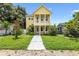 Two-story yellow house with front yard and walkway at 2430 6Th N Ave, St Petersburg, FL 33713