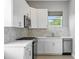 Modern white kitchen with stainless steel appliances and subway tile backsplash at 2430 6Th N Ave, St Petersburg, FL 33713