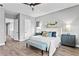 Main bedroom with king bed, blue bench, and gray nightstands at 2430 6Th N Ave, St Petersburg, FL 33713