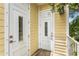 Rear exterior of home with two white doors and yellow siding at 2430 6Th N Ave, St Petersburg, FL 33713