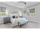 Main bedroom with king-size bed and teal patterned bench at 2430 6Th N Ave, St Petersburg, FL 33713