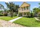 Two-story yellow house with front yard and walkway at 2430 6Th N Ave, St Petersburg, FL 33713