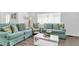 Living room with light teal sofas and a coffee table at 104 11Th S Ave, Safety Harbor, FL 34695