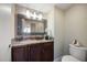 Vanity with granite countertop and dark wood cabinets at 1540 Gulf Blvd # 2102, Clearwater Beach, FL 33767