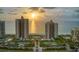 Aerial sunset view of resort with beach, tennis courts and pool at 1540 Gulf Blvd # 2102, Clearwater Beach, FL 33767
