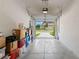 Garage with open door, view of the street, and storage boxes at 7203 Sweet Alyssum Ct, Tampa, FL 33619