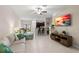 Open living room with light walls, tile floor, and a view of the kitchen at 7203 Sweet Alyssum Ct, Tampa, FL 33619