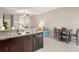 Modern kitchen with dark cabinets, granite counters, and breakfast nook at 7203 Sweet Alyssum Ct, Tampa, FL 33619