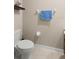 Simple bathroom with toilet, neutral walls, and a towel bar at 7203 Sweet Alyssum Ct, Tampa, FL 33619