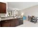 Kitchen with dark brown cabinets, granite countertops, and a breakfast bar at 7203 Sweet Alyssum Ct, Tampa, FL 33619