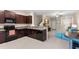 Modern kitchen with dark cabinets, granite counters, and stainless steel appliances at 7203 Sweet Alyssum Ct, Tampa, FL 33619
