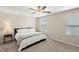 Spacious bedroom with carpeted floor, large bed, and ceiling fan at 7203 Sweet Alyssum Ct, Tampa, FL 33619